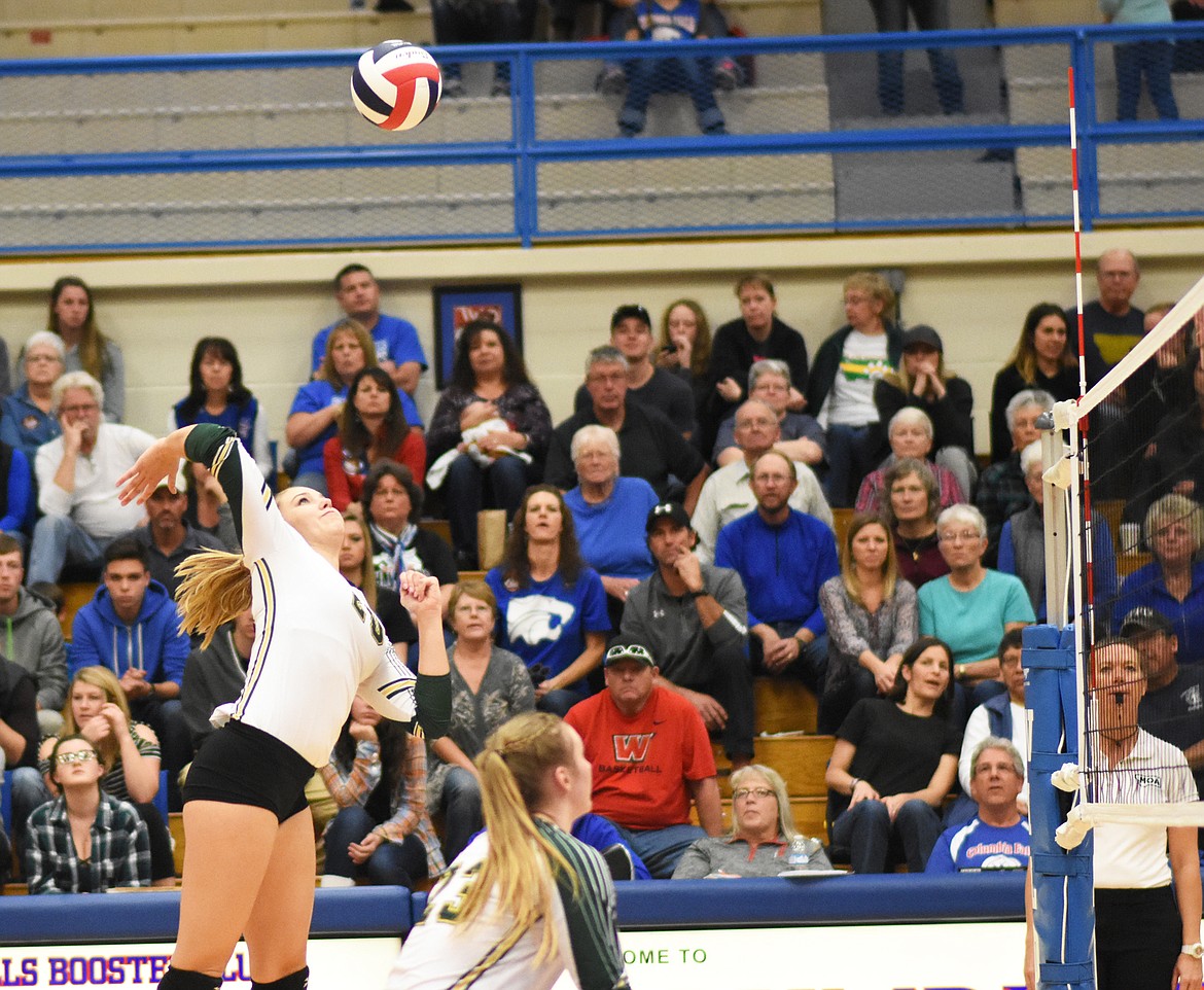 Cailyn Ross rises for a spike against Columbia Falls during the Western A divisional title match Saturday at Columbia Falls High School.