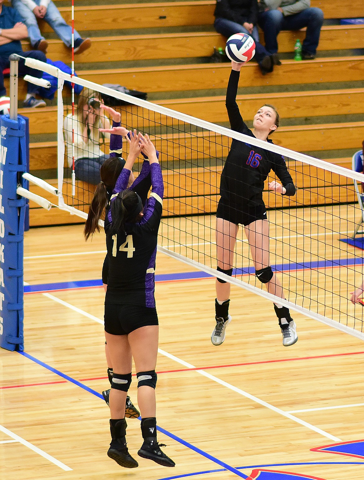 Keavyn Baker spikes the ball over the net against Polson.