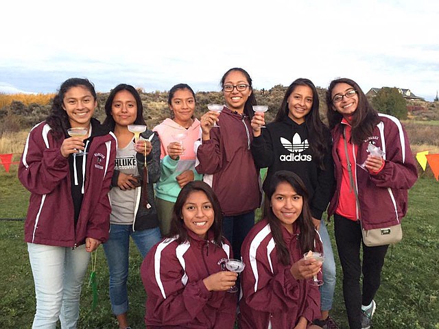 David Miskimens Photo - The Wahluke girls celebrate their 2nd place finish at Apple Ridge and berth in the state meet with apple cider at Apple Ridge. From left, they are (kneeling) Brisa Mendoza and Lluviana Mendoza; (standing) Claudia Olivares, Alma Velasco, Maria Sanchez, Jessica Arellano, Stephanie Valdespino and Jennifer Navarrete.