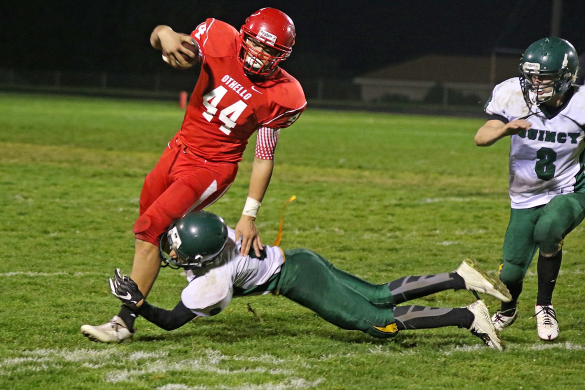 Bob Barrett Photo - Othello's Asai Villarreal lowers his shoulder as Quincy's Gates Petersen prepares to make the tackle.