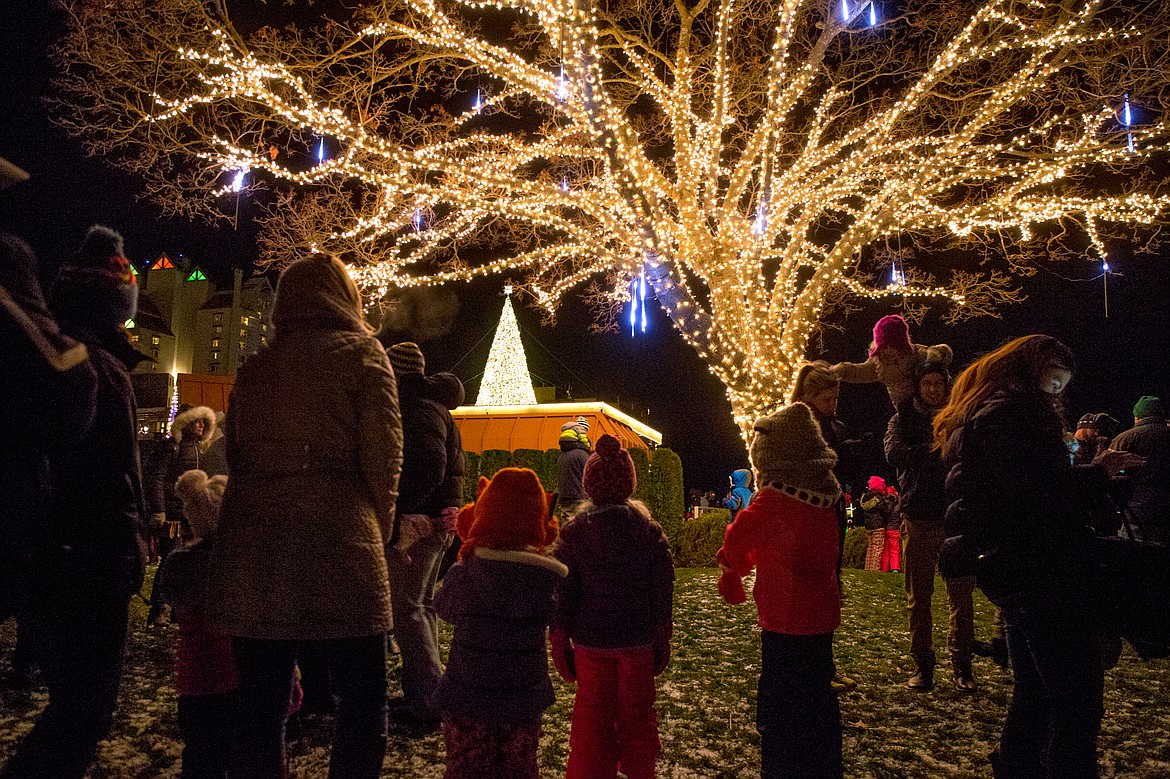 JAKE PARRISH/Press file

Families gather underneath a fully lit-up tree as the Christmas tree atop the Hagadone Corporate Offices stands out against the night sky in the distance on Friday, Nov. 27, 2015 at the Coeur d&#146;Alene Resort Holiday Light Show.