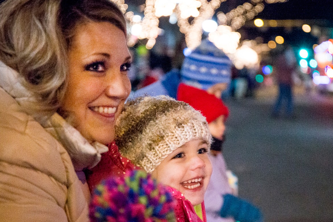 JAKE PARRISH/Press file

Halle Hatfield, 3, and her mother Drue smile as they watch the holiday &#147;Cool Yule&#148; parade floats move down Sherman Avenue on Friday, Nov. 27, 2015 in Coeur d&#146;Alene before the Coeur d&#146;Alene Resort Holiday Light Show.