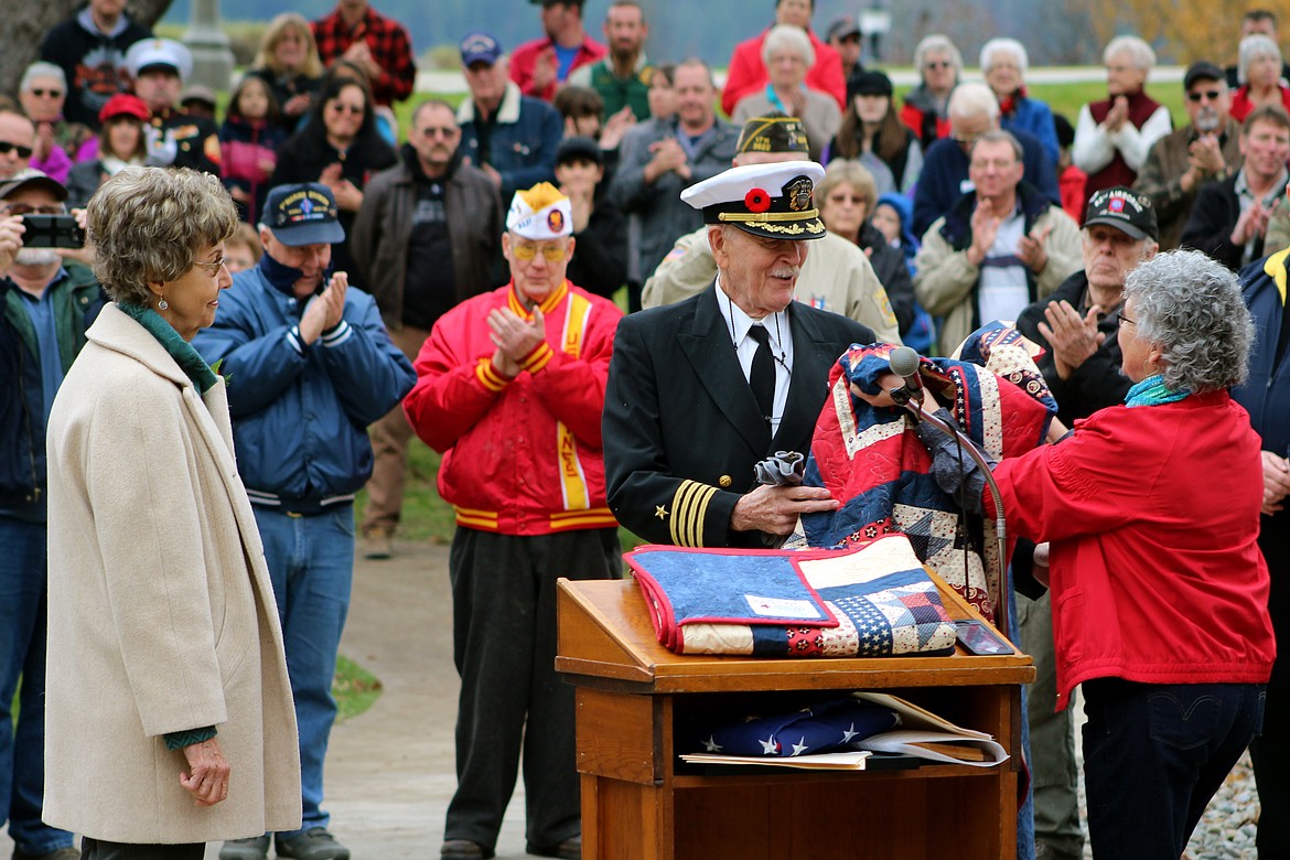 &#151;Photo by STAR SILVA
Margaret Mellet, right, presents Naval Capt. Leonard LeShack with an honorary quilt on Friday during the Veterans Day Ceremony. Evelyn Rae, left, was also chosen as an honorary recipient. Both Rae and LeShack were chosen because of their service during the Vietnam War.