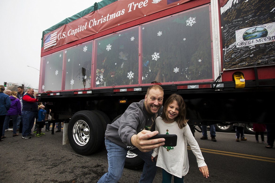 LOREN BENOIT/PressJonathan Brandel and his 7-year-old daughter, Audrey, take a selfie next to the U.S. Capitol Christmas tree Friday morning in downtown Coeur d'Alene. The 80-foot Engelmann Spruce is from the Payette National Forest and is the second U.S. Capitol tree from Idaho. The tree will make 15 stops in Idaho, including the Idaho State Capitol in Boise on Monday.