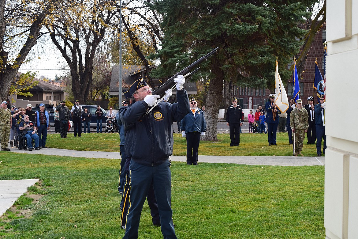 Joel Martin/Columbia Basin Herald
A line of veterans offer a rifle salute at the Vietnam War Memorial in front of the Grant County Courthouse following Friday&#146;s Veterans Day Parade.