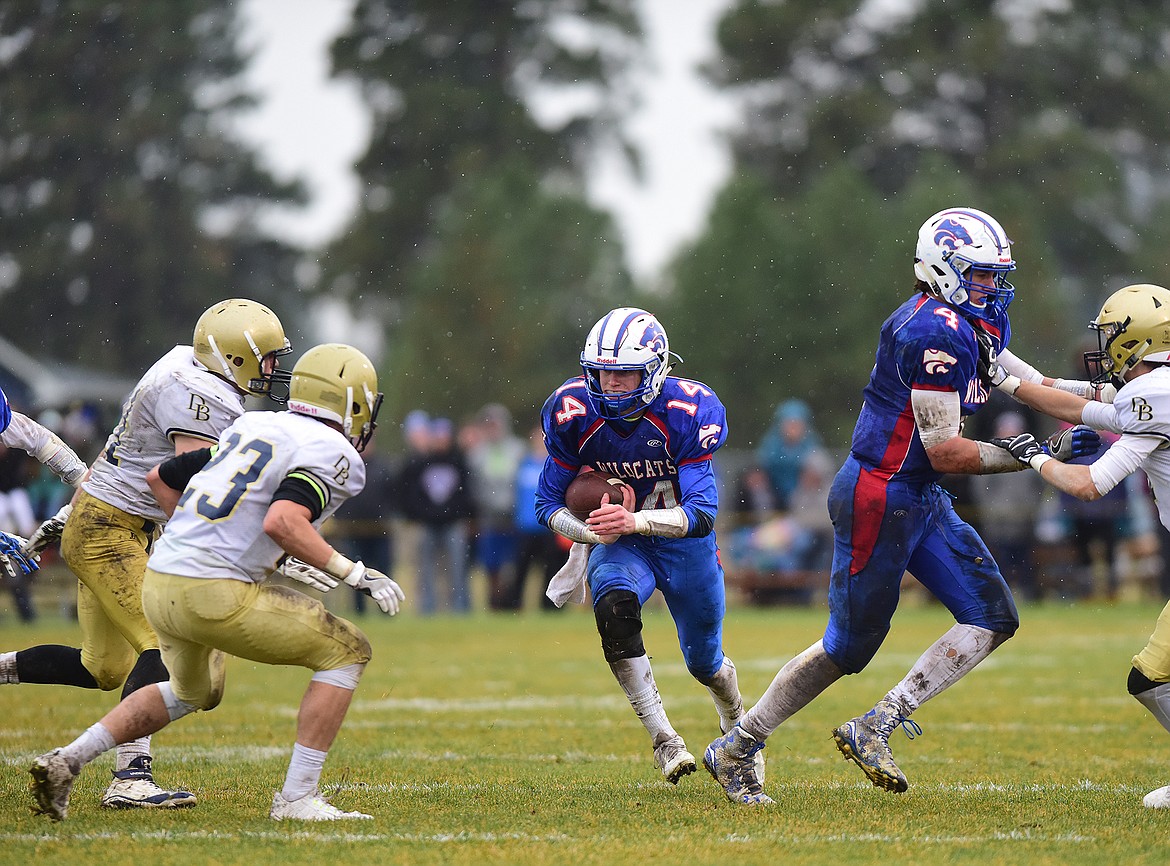 Steven Decamp, center looks to split teh defense while Trevor Hoerner, right, blocks.