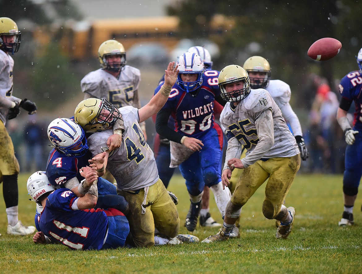 Dillon&#146;s R.J. Fitzgerald loses the ball as Trevor Hoerner and Ben Windauer haul him down.