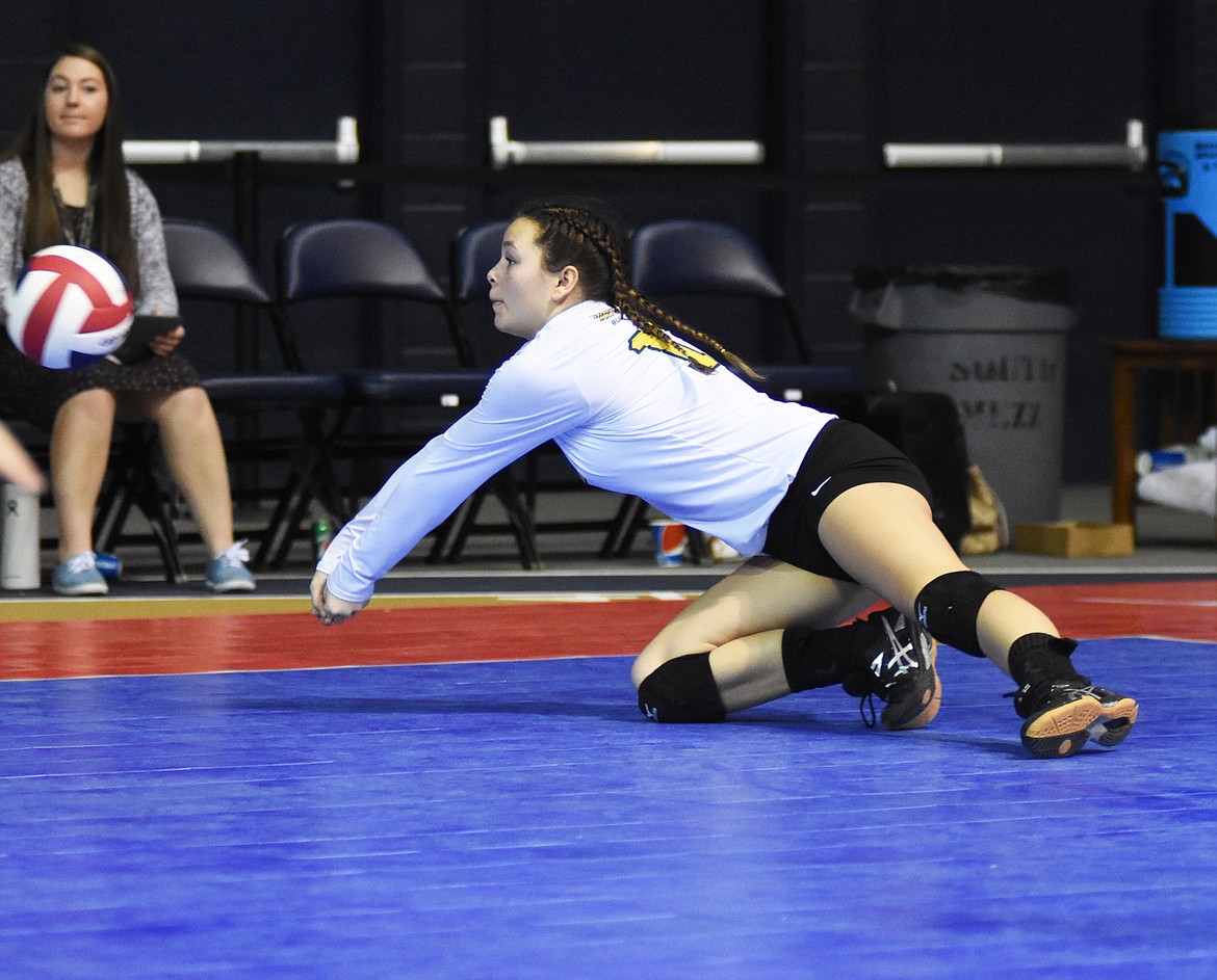 Serena Hemmingson dives for a dig against Billings Central.