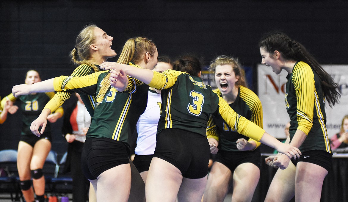 The Lady Bulldogs celebrate during the Class A state volleyball tournament in Bozeman.