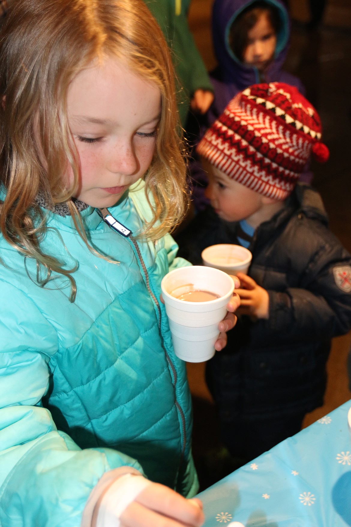 &#151;Photo by CAROLINE LOBSINGER
Ida and Kit Gaddess enjoy a cup of hot cocoa as they wait for the start of the Christmas tree lighting ceremony and for the arrival of Santa Claus.