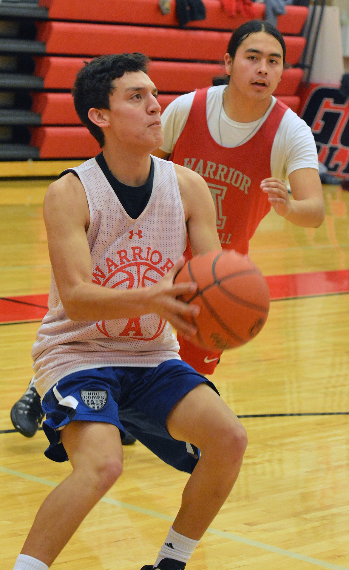 ARLEE BASKETBALL Player Greg Whitesell (with the ball) shots teammate Alex Moran pressuring him during the Friday morning practice at Arlee High School. (Jason Blasco/Lake County Leader)