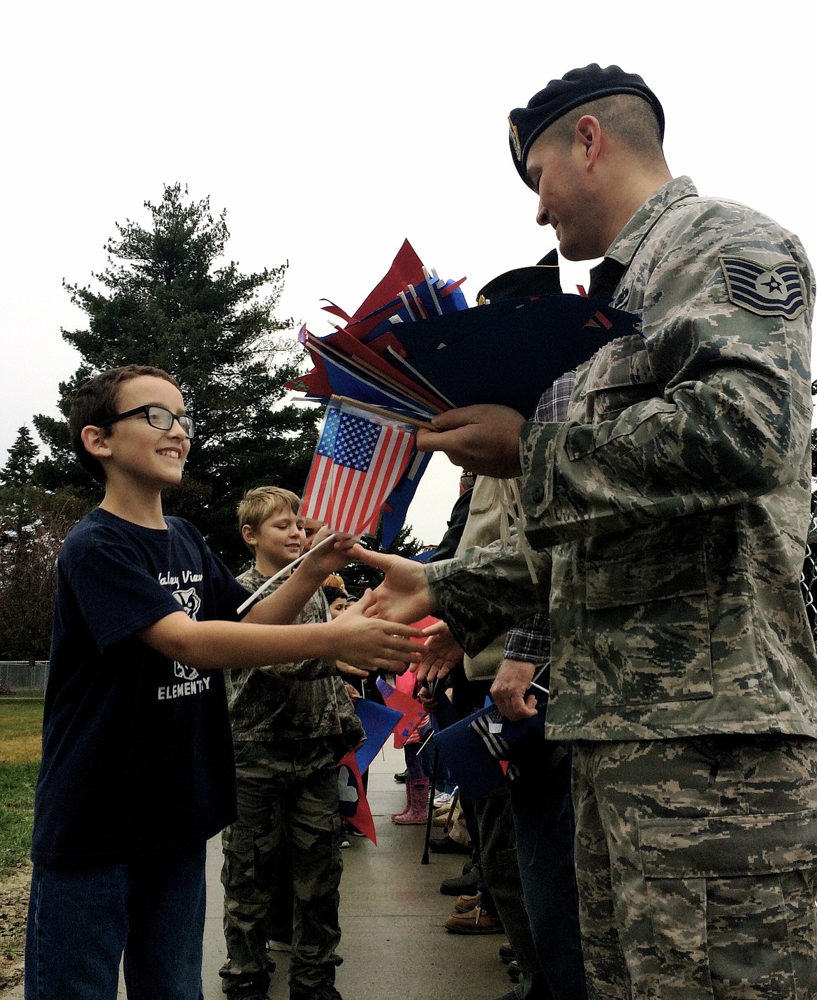 &#151;Courtesy photo
Chandler Swanson shakes hands with Airman TSgt Shane Banks during the Veterans Day ceremony at Valley View Elementary School on Nov. 10. Close to 400 students, Pre-K through fifth grade, were in attendance, along with about 15 or so Veterans, our local Veterans of Foreign Wars and American Legion Posts. Air Force TSgt Shane Williams helped fifth grade students raise the flag as the Bonners Ferry High School band played the National Anthem. Upon conclusion of the ceremony, about half of the teachers had their students walk past the Veterans in attendance and give them flags, high fives, and fist bumps, along with a cascade of &#147;thank yous&#148; for protecting our country.  It was a heart-warming ceremony that will no doubt leave a lasting impression on both our students and Veterans!