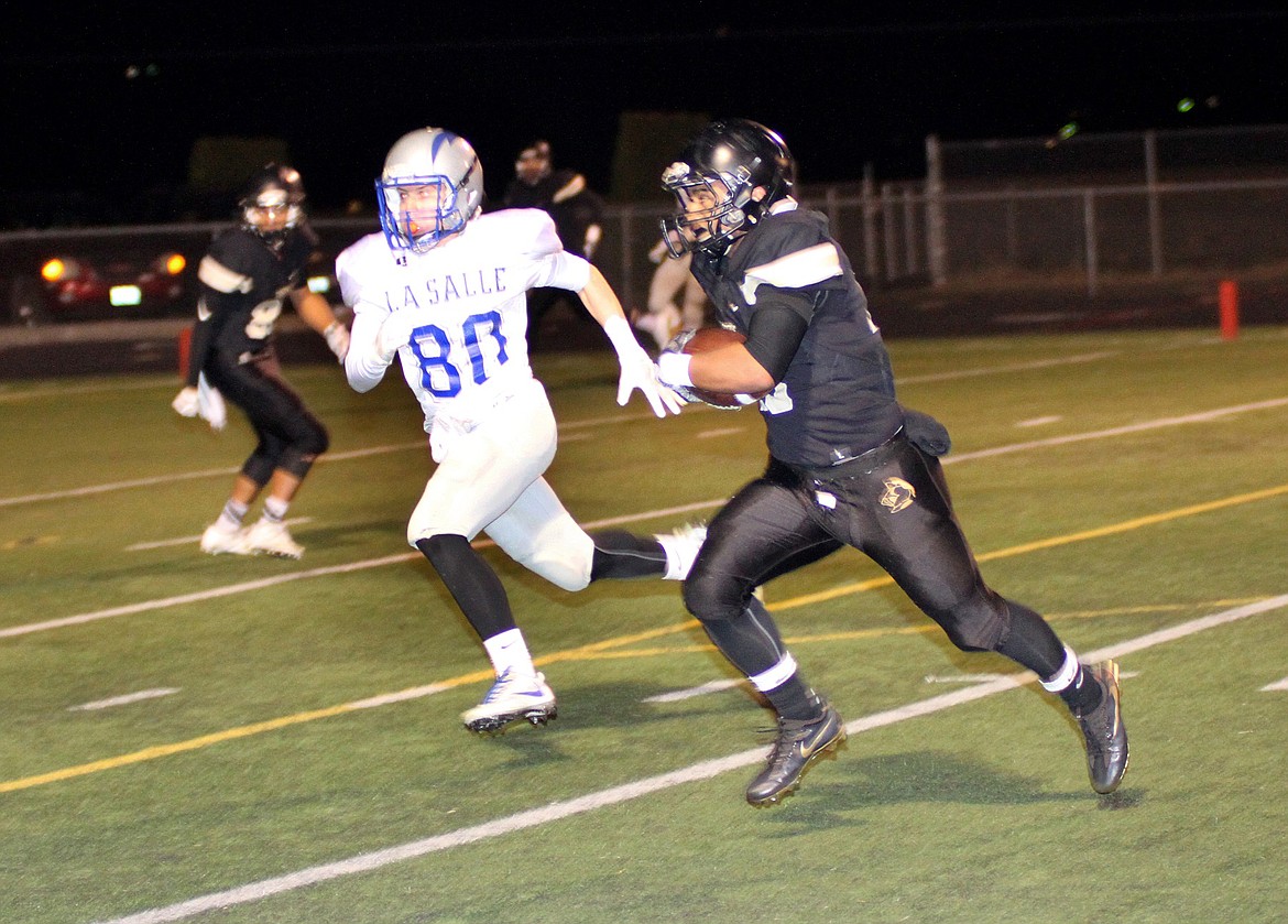 Pete Christensen - Photo Receiving a 29-pass from quarterback Kaden Jenks on the last play of the half, Juan Niebla runs to the one-yard line.