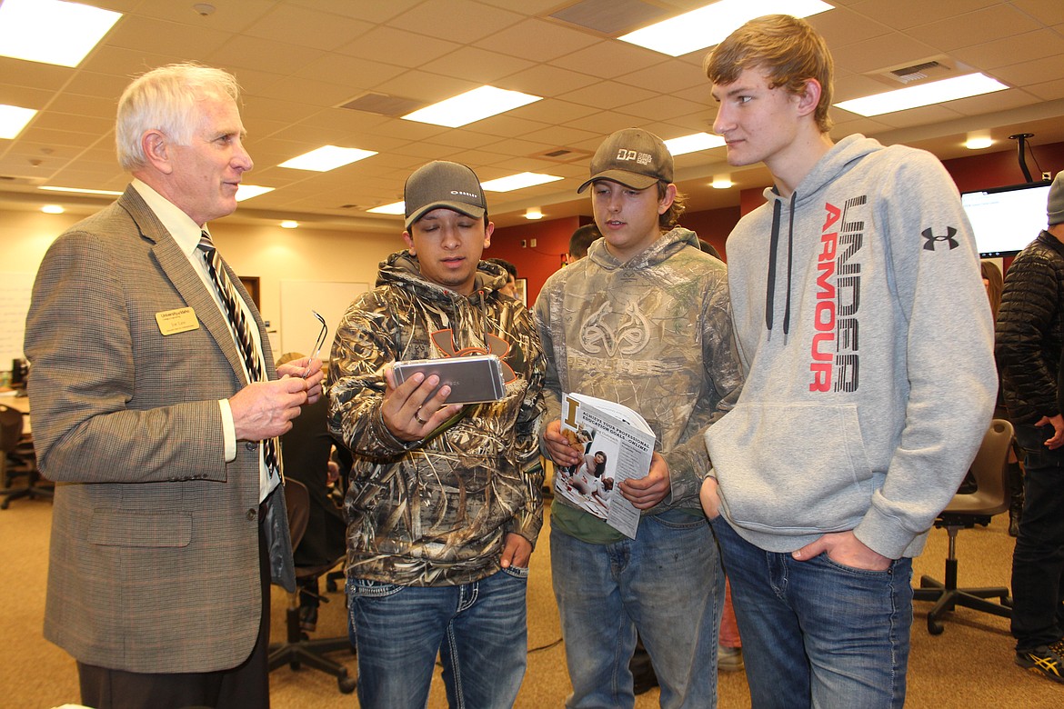 Cheryl Schweizer/Columbia Basin Herald
Joe Law (left) of the University of Idaho talks about the work the university is doing with NASA with (from left) Jesus Lopez and Blake Driesen, both of Ephrata, and Ivan Dubineti of Moses Lake. Law was in Moses Lake to talk to students on Engineering Night at Big Bend Community College.