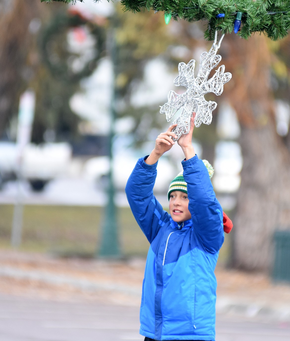 Volunteers descended on downtown Whitefish Sunday morning to hang up the winter decorations.