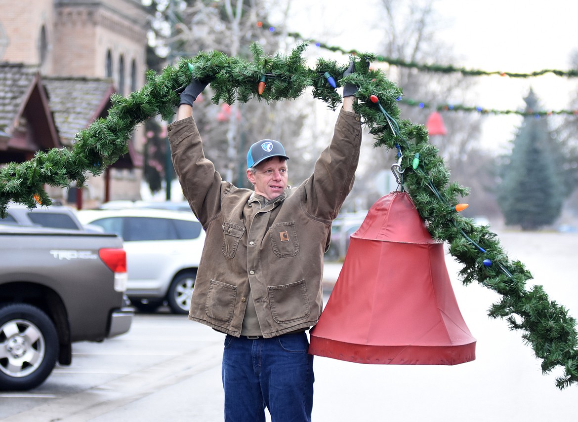 Volunteers descended on downtown Whitefish Sunday morning to hang up the winter decorations.