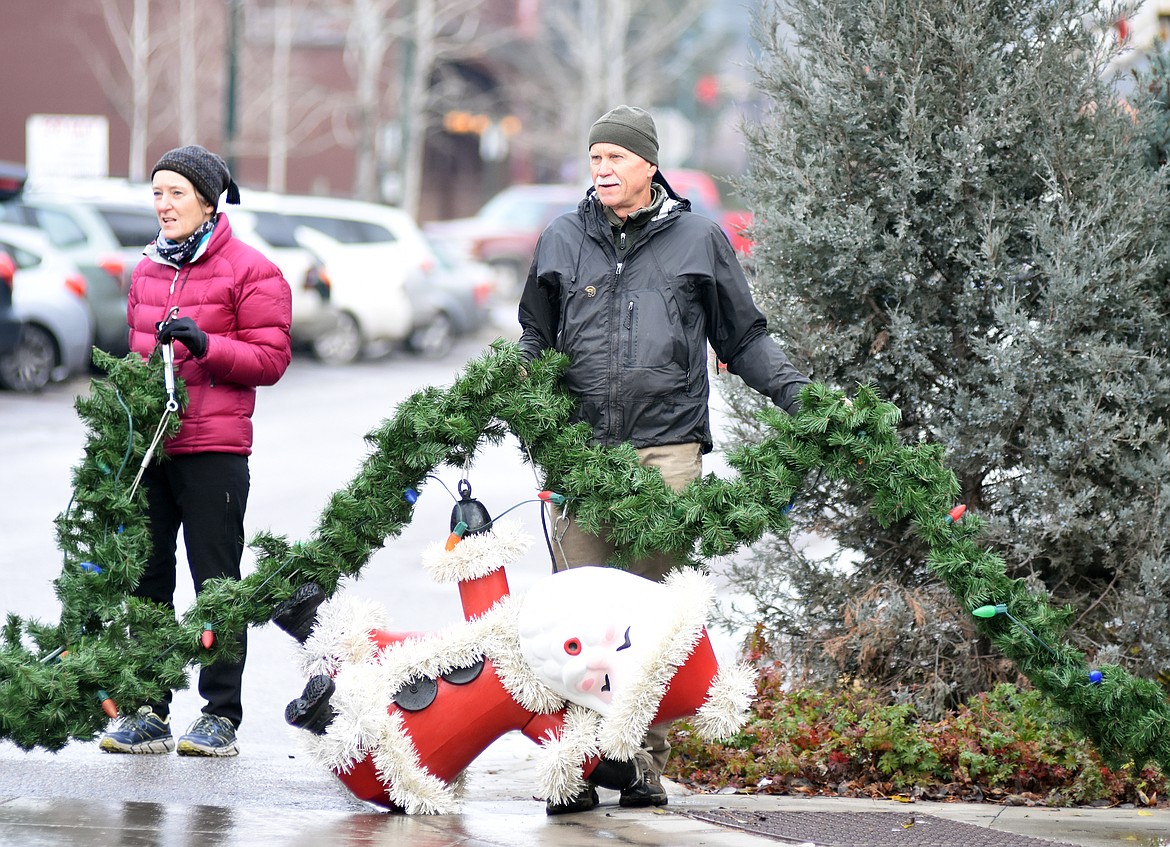 Volunteers descended on downtown Whitefish Sunday morning to hang up the winter decorations.