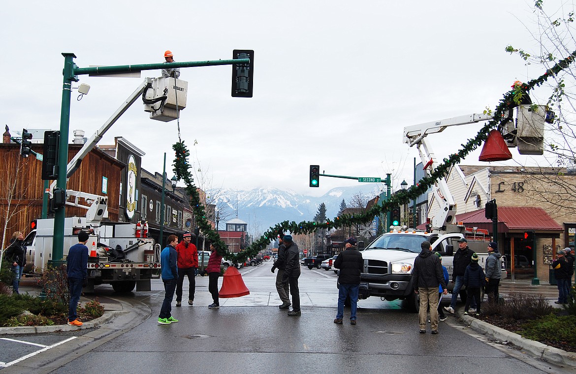 Volunteers descended on downtown Whitefish Sunday morning to hang up the winter decorations.