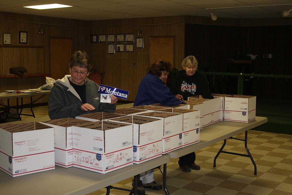 BECKY POWLEY, Bibi Smith and Carol Harris loading boxes Monday morning. (Clark Fork Valley Press photos)