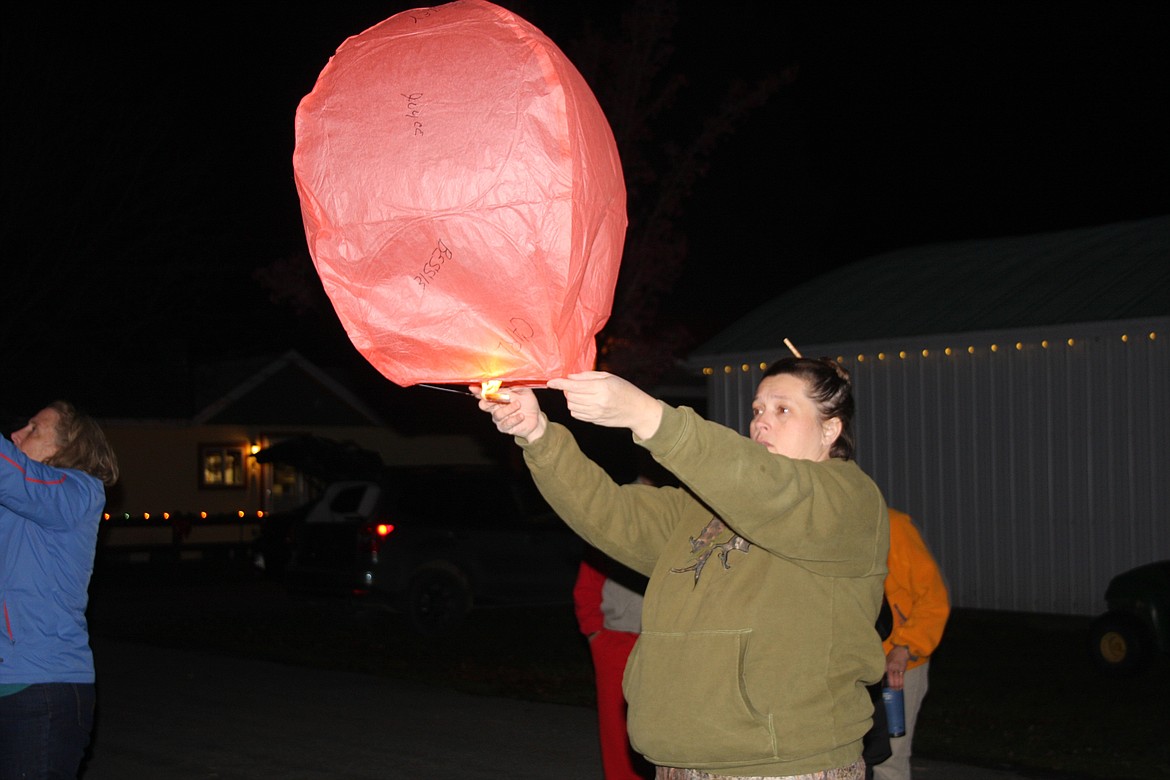 KELLY VONHEEDER lights a lantern at the Cancer Network of Sanders County's event Saturday, Nov. 26 at the Sanders County Fairgrounds. (Clark Fork Valley Press photo)