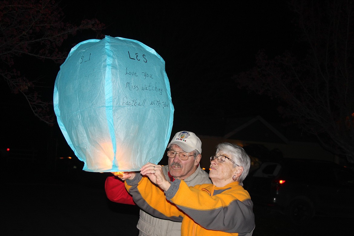 JERRY AND Marge Kohm light a lantern. (Clark Fork Valley Press photo)