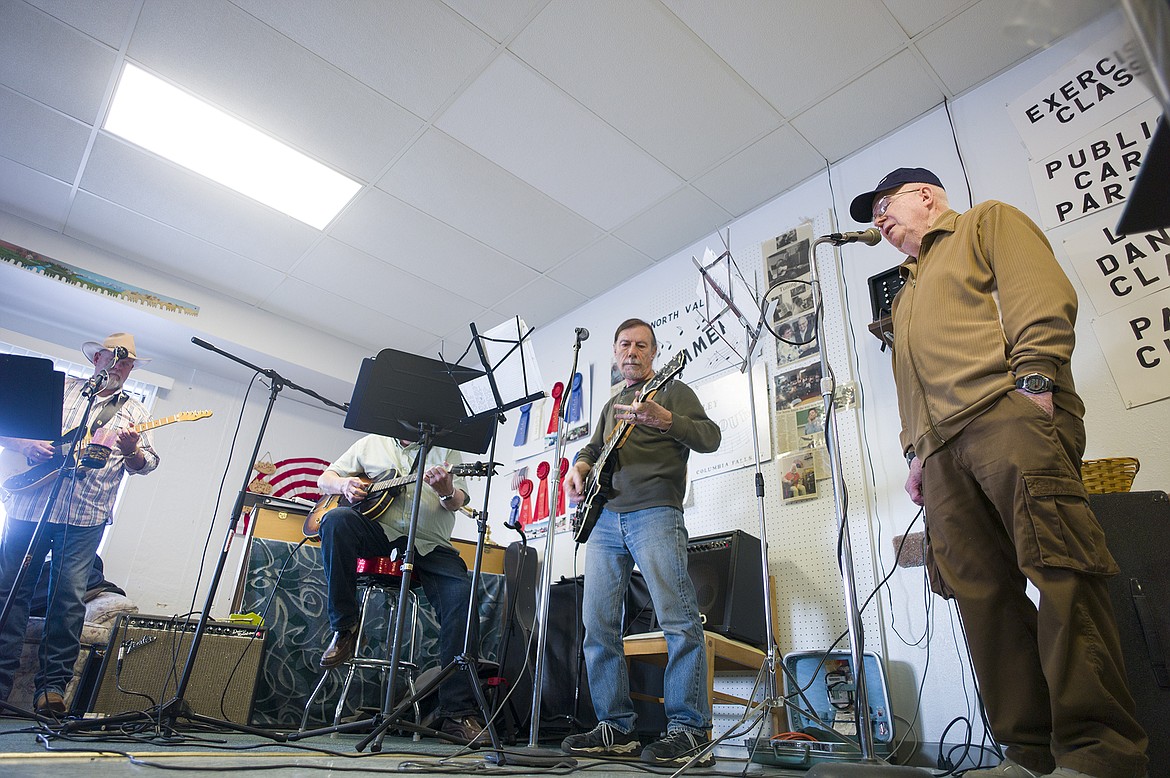 Larry Snyder, far right, sings a tune while Rick King and Dick Reed play guitar.