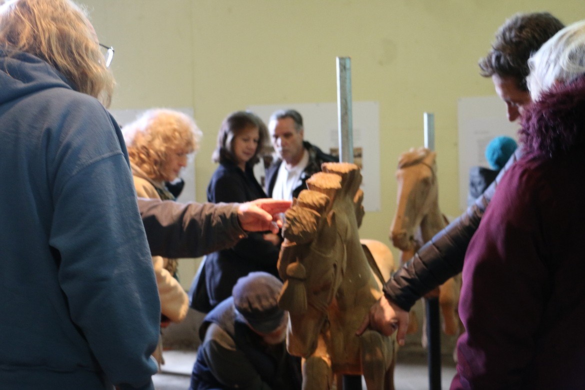 &#151;Photo by MARY MALONE
About 150 people enjoyed petting the 36 hand-carved wooden horses that are part of a 1920 carousel. Its new owners, Clay and Reno Hutchison, plan to restore the nearly 100-year-old machine and find it a home in Sandpoint.