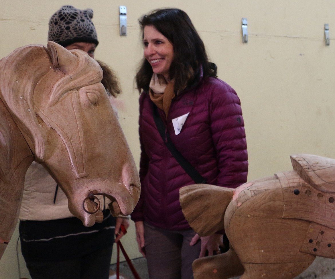 &#151;Photo by MARY MALONE
Reno Hutchison, right, of Sandpoint, could barely contain her excitement and tears of joy as about 150 people showed up Saturday at the Sandpoint Granary Warehouse to see the 1920 carousel, purchased 16 years ago by Hutchison and her husband, Clay, removed from its storage trailers after 64 years.