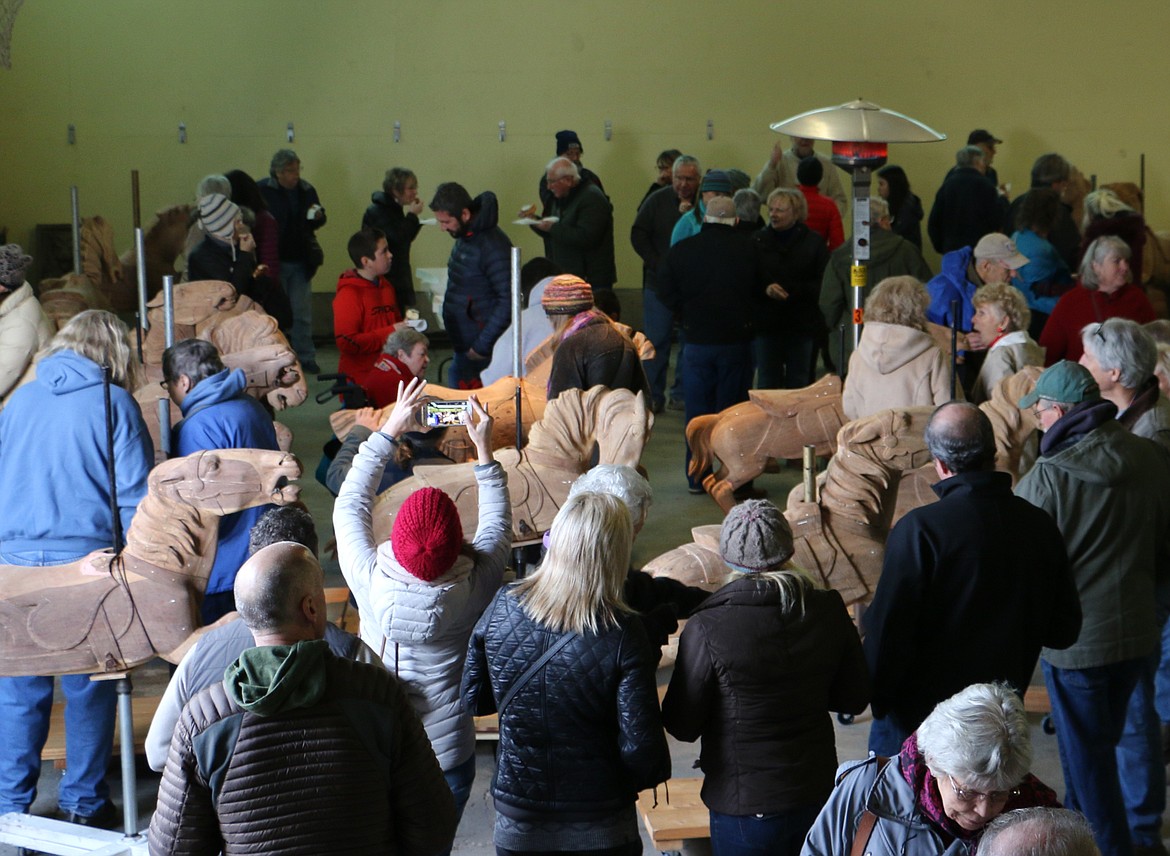 &#151;Photo by MARY MALONE
A 1920 carousel was released from its 64-year slumber Saturday by its new owners, Clay and Reno Hutchison, at the Sandpoint Granary Warehouse where about 150 people showed up to see the old machine with its hand-carved wooden horses, which after restoration, will find a home in Sandpoint.