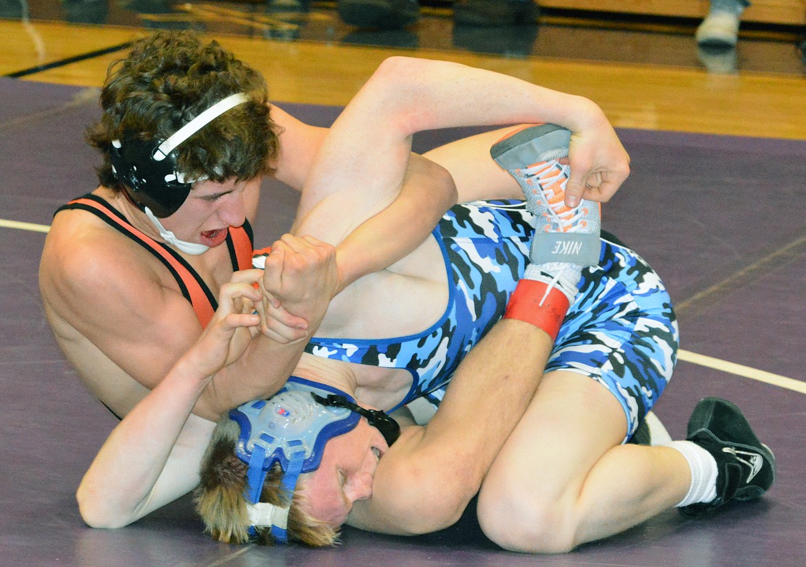 RONAN WRESTLER Seth Cheff attempts to pin an opposing wrestler at the Owen Invitational Saturday at Linderman Elementary School. (Jason Blasco/Lake County Leader)