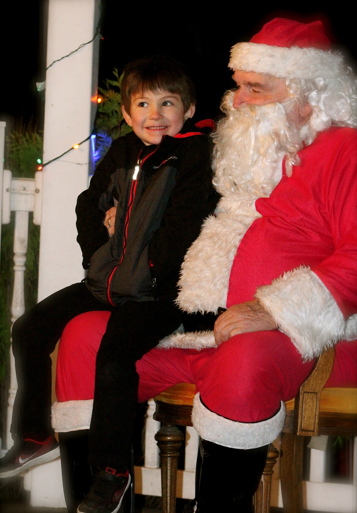 Tristan Vignari, 5, poses with Santa Claus on Nov. 25, at Georgia Mae Plaza, downtown Bonners Ferry.
&#151;Photo by STAR SILVA