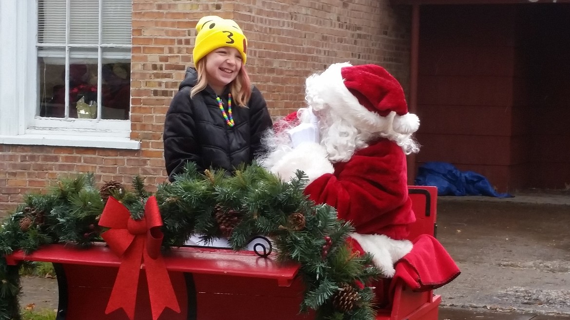 Santa visits with Elli outside the Old Schoolhouse in Superior on Dec. 3 as part of the Wells Fargo Holiday Stroll.