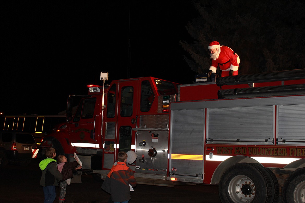 Santa arrived on a fire truck in DeBorgia as children gathered to greet him last Thursday as part of the annual Schoolhouse Lighting event. (Kathleen Woodford photos/Mineral Independent)