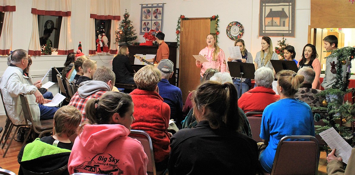 Members of St. Regis School band and choir led a holiday music sing-along at the DeBorgia Schoolhouse on Dec. 1. (Photo by Kathleen Woodford/Mineral Independent)