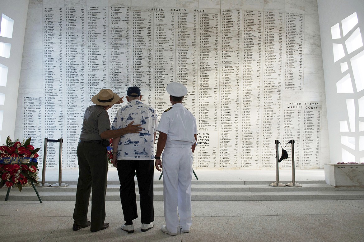 In this June 6, 2013 photo provided by the USS Arizona Memorial Foundation, Lauren Bruner, one of five remaining survivors of the USS Arizona from the Dec. 7, 1941, Japanese attack of Pearl Harbor, is joined by Capt. Jeffry W. James, right, then the commander of Joint Base Pearl Harbor-Hickam, and Daniel Martinez, chief historian for the National Park Service, as they look at the Arizona Memorial&#146;s Shrine Wall with names of every man aboard the ship when it was attacked. More than 2,300 servicemen died in the Japanese attack that plunged the United States into World War II. Nearly half of those killed were on the Arizona, most still entombed in the wreckage. (Mark Comon/USS Arizona Memorial Foundation via AP)