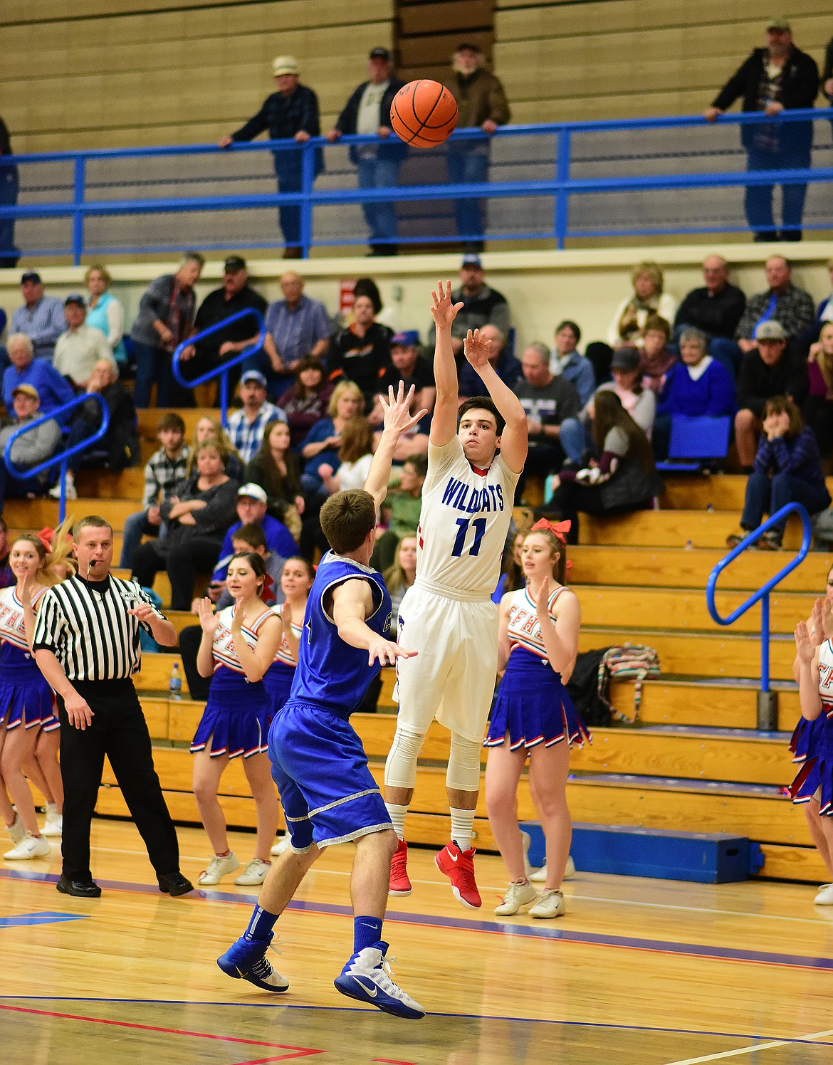 Logan Stephens shoots a trey against Corvallis.