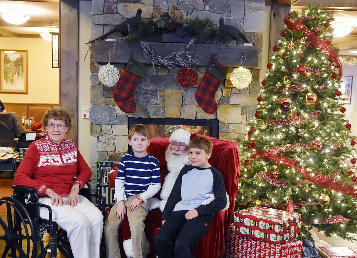 Dorothy Mundt along with great-grandsons Trevor and Taite Hammer visits with Santa Saturday at The Springs at Whitefish.