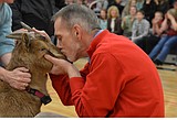 Making good on a promise, principals kiss a goat