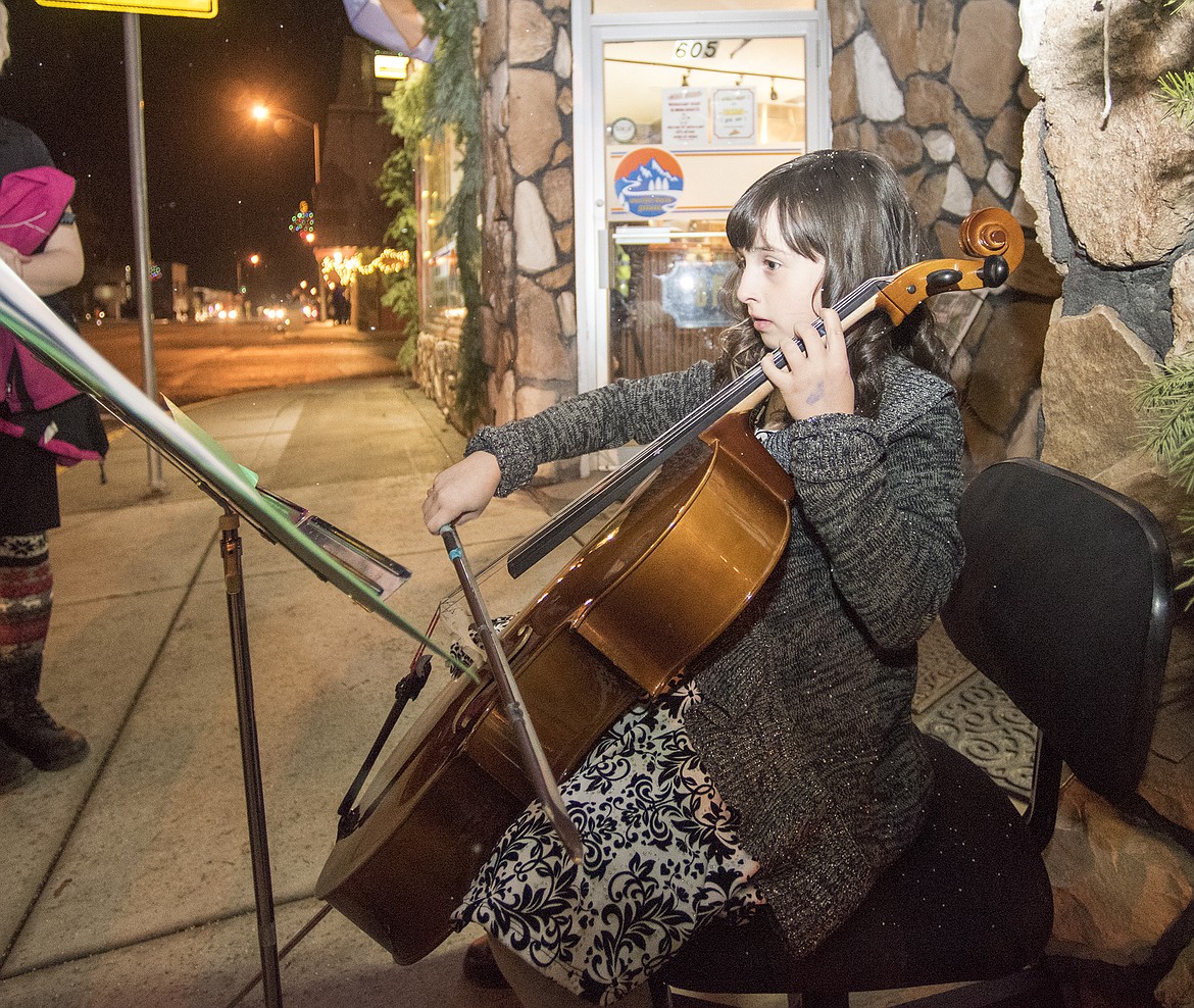 Hailey Simon plays the cello on Nucleus Avenue before the start of the parade.