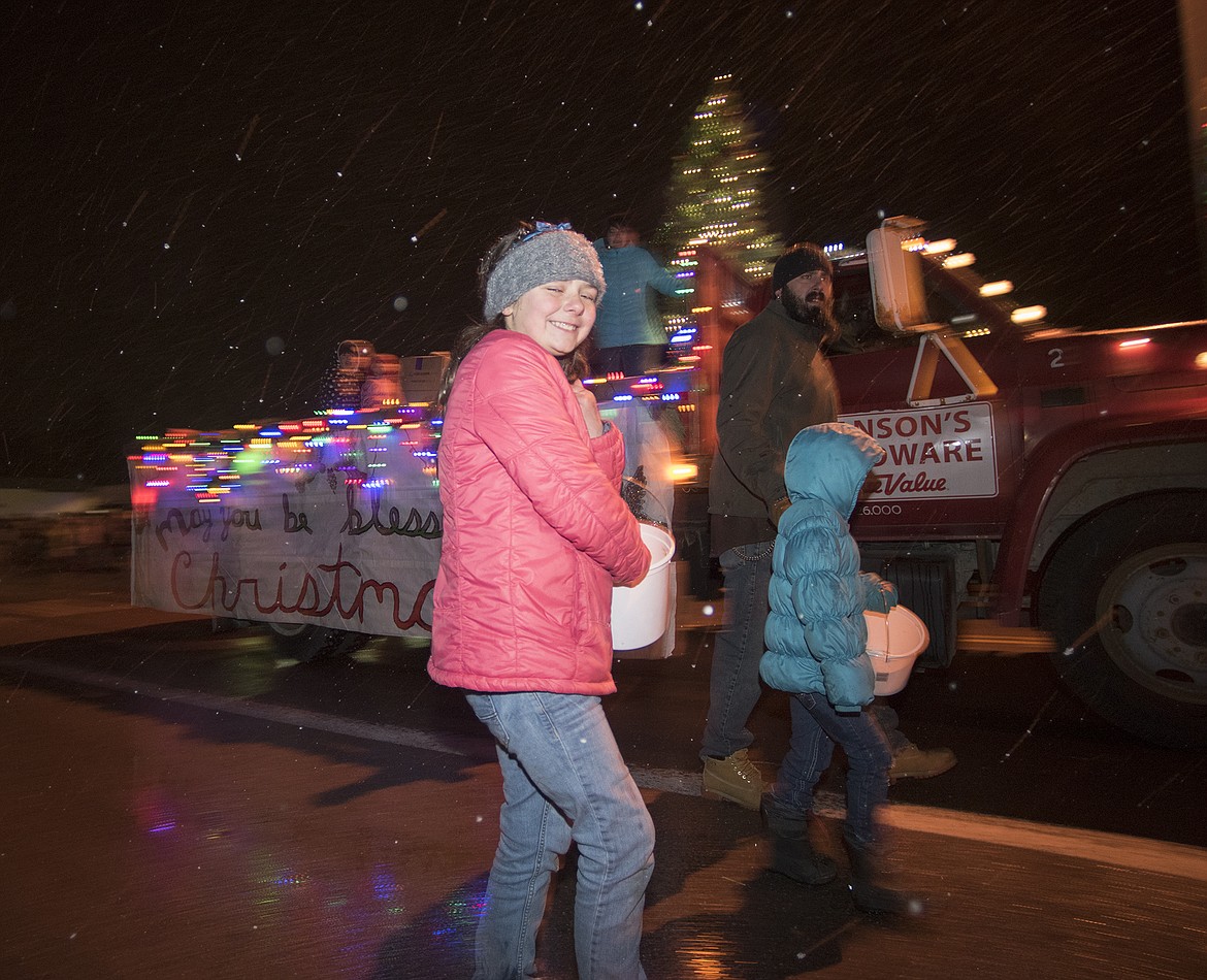 A youngster hands out candy from the Hanson&#146;s Hardware float.