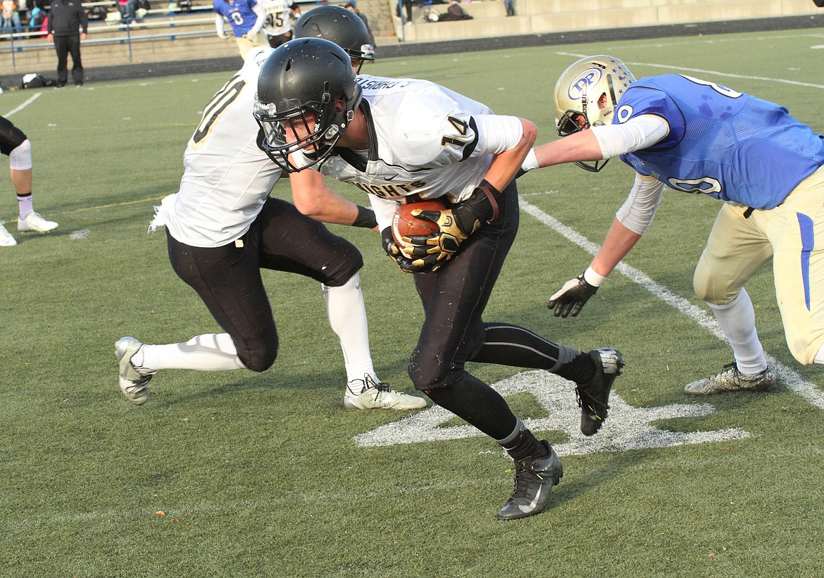 Pete Christensen Photo - Corbin Christensen intercepts a Deer Park pass, and Kaden Jenks prepares to block a potential tackler.