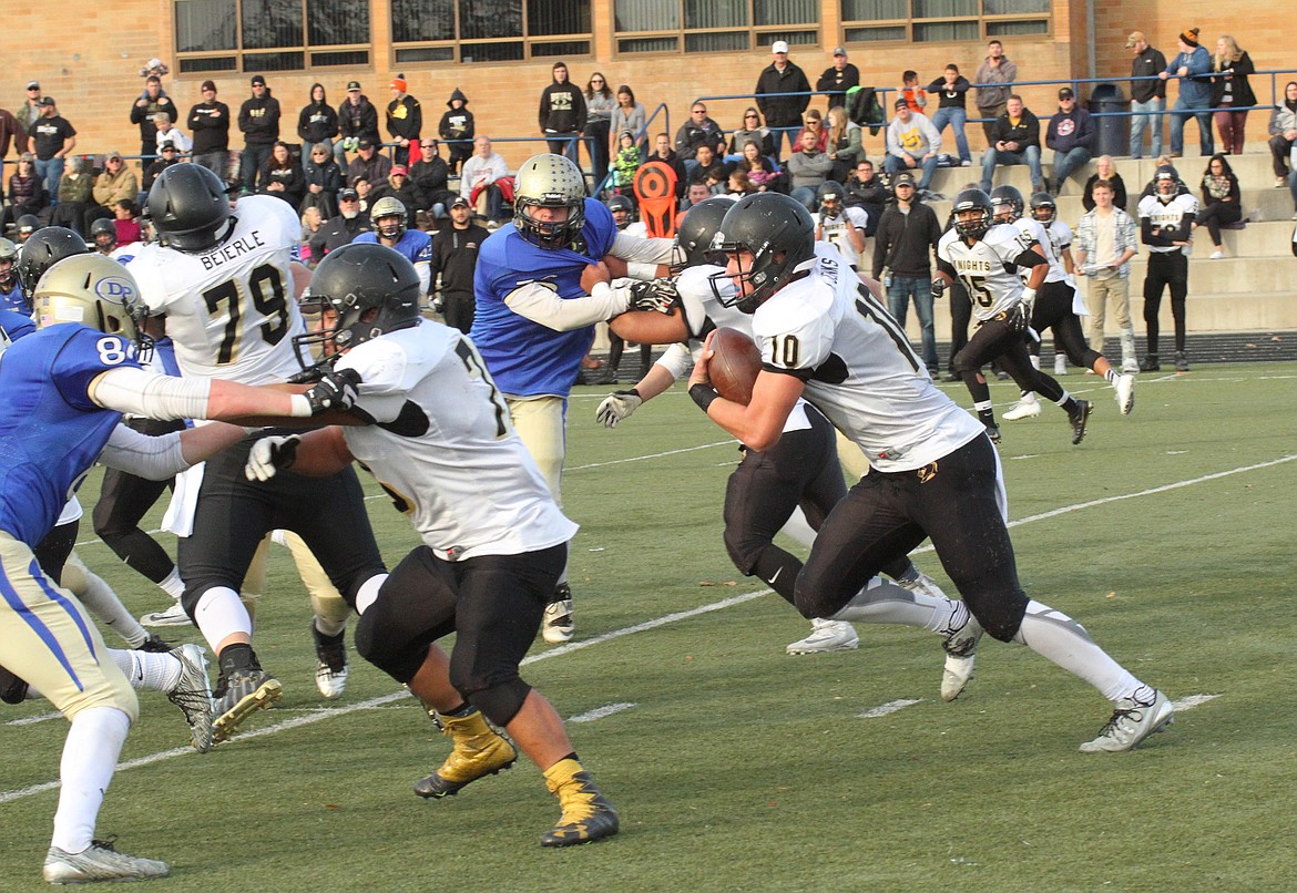 Pete Christensen Photo - Kaden Jenks charges to a hole in the Deer Park line created by Juan Hernandez and Raynor Beierle.