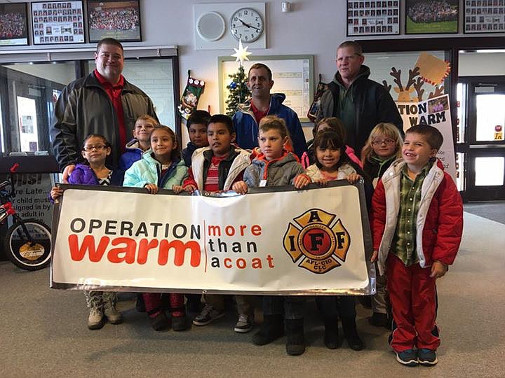 Moses Lake Firefighters/courtesy photo
Moses Lake firefighters hand out warm winter coats at Midway Elementary on Tuesday.