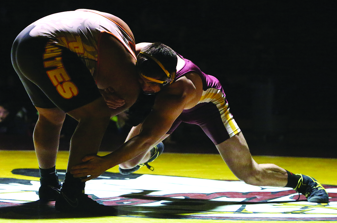 Connor Vanderweyst/Columbia Basin Herald
Moses Lake's Payton Castro reaches for the leg of Davis' Daniel Fuentes.