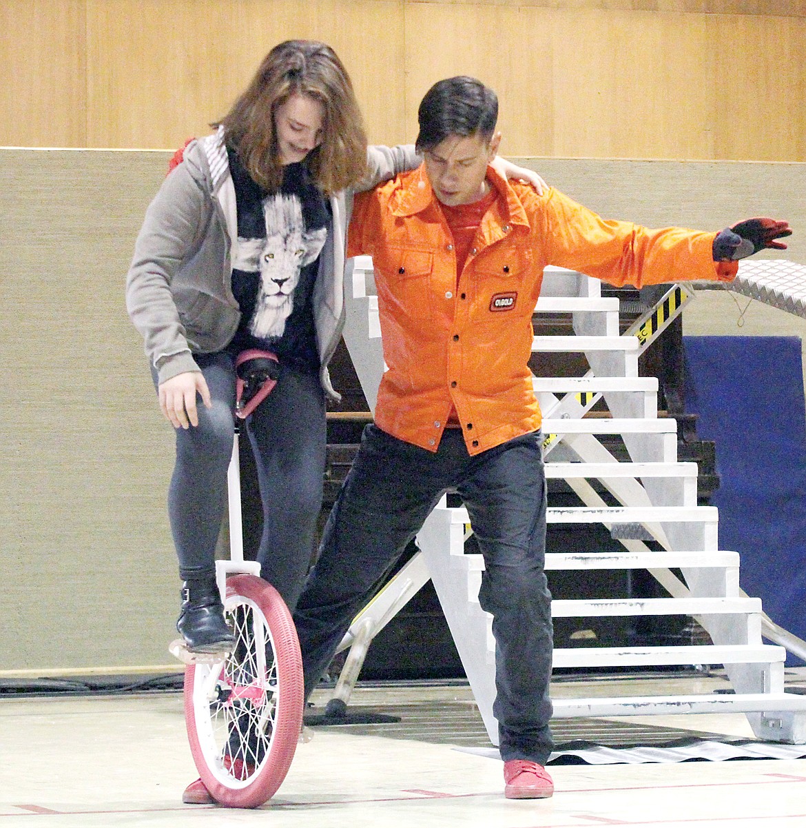 Alisha Thomson goes for a short test ride with the aid of world champion unicyclist Dustin Kelm Tuesday at Kootenai Valley Christian School. (Paul Sievers/TWN)