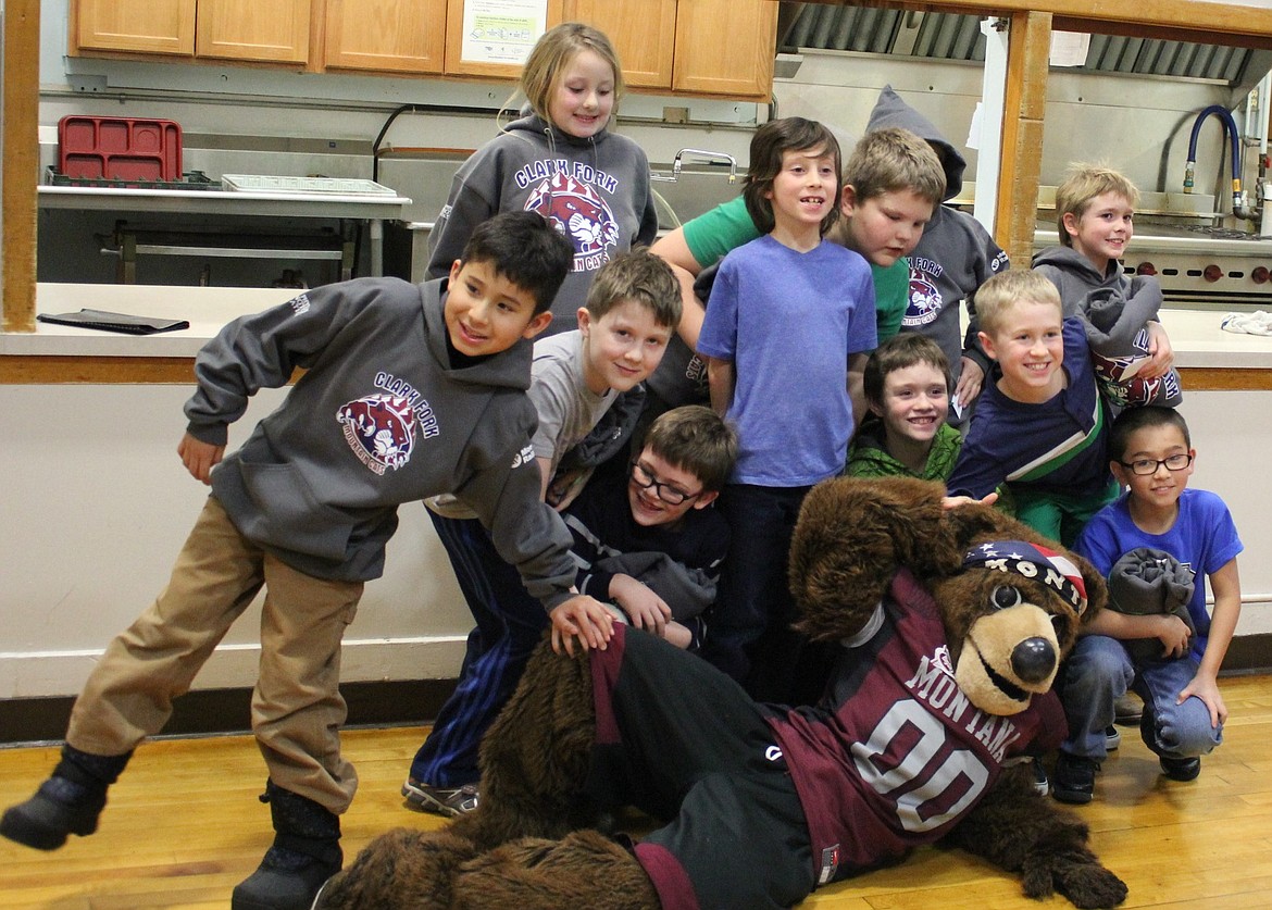 LEFT: Alberton students enjoy a photo op with UM&#146;s mascot, Monte. All the students received a sweatshirt with the school&#146;s logo as part of the Montana Rail Link and Dennis and Phyllis Washington Foundation&#146;s &#147;Operation Sweatshirt.&#148; (Kathleen Woodford/Mineral Independent)