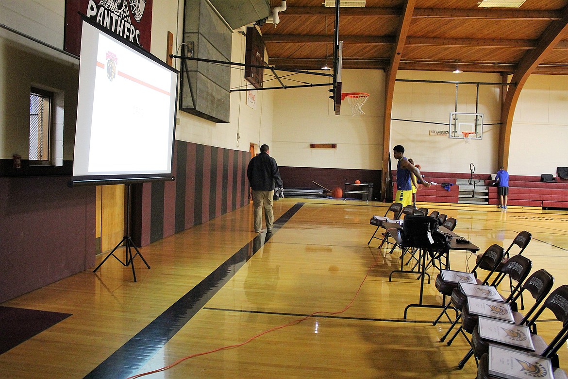 San Jose State basketball crew members set up a screen to watch film in the Alberton gym on Tuesday before their game against the Montana Grizzlies on Dec. 7. (Photo by Kathleen Woodford/Mineral Independent)