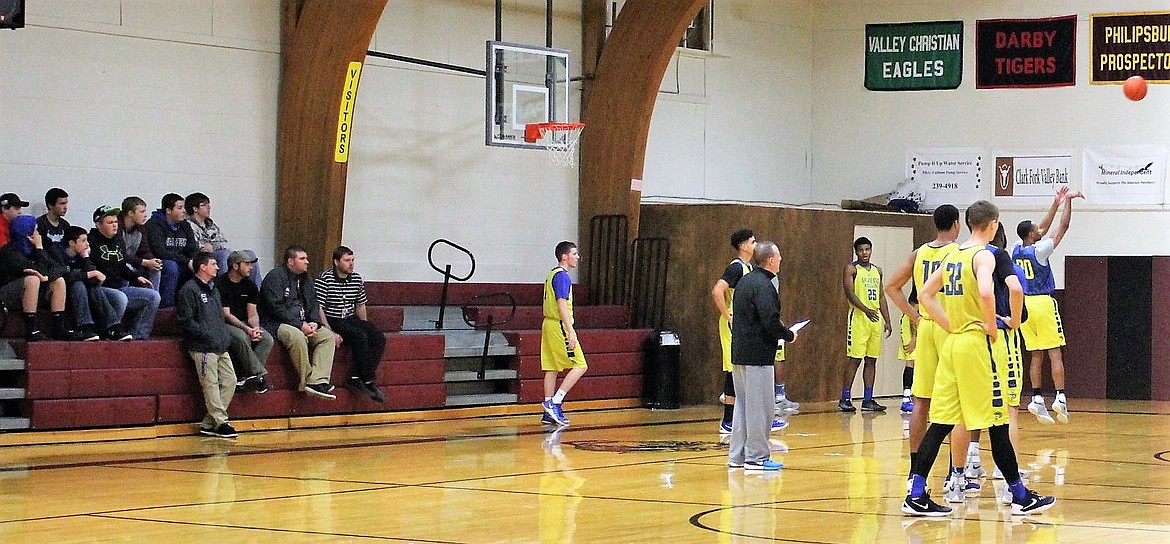 The boys Clark Fork Mountain Cats basketball team and coaches watch as the San Jose team practices for their game against the Montana Grizzlies on Wednesday, Dec. 7. (Kathleen Woodford/Mineral Independent)