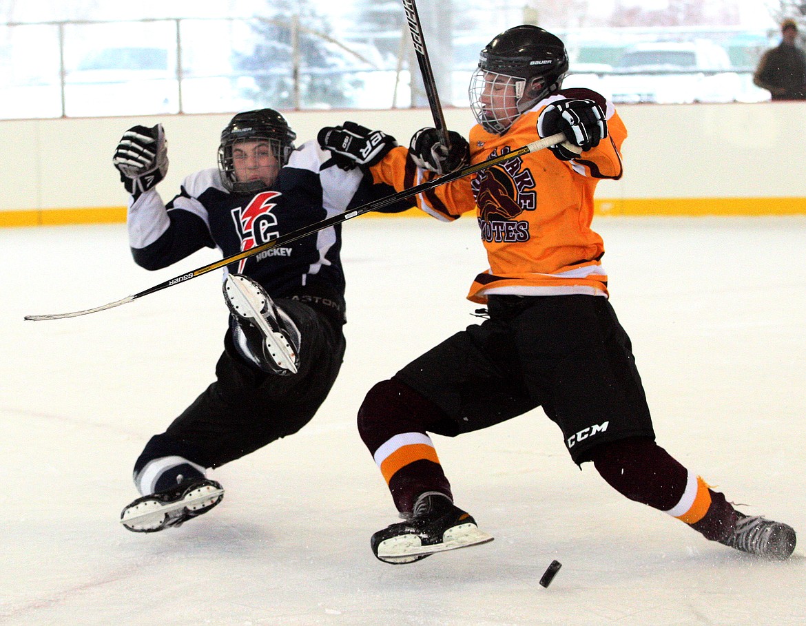 Rodney Harwood/Columbia Basin Herald
Moses Lake forward Cole Tabert (right), sends Lewiston&#146;s aaron Gramm flying during Satufday&#146;s 5-3 loss in the morning game at Larson Recreation Center.