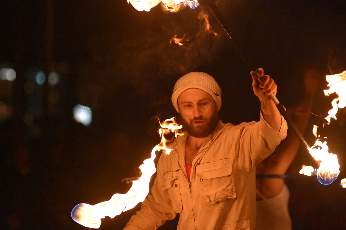 A member of WhiteFire fire dancers performs on Central Avenue Friday night during the Whitefish Christmas Stroll.